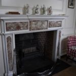 The marble of the fireplace survived the internal fire and was restored with the house