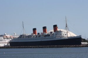 RMS Queen Mary, built c. 1936 for Cunard-White Star Line, operated as a troop ship in WWII, operates as a museum in Long Beach, CA today. (photo CC by SA 2.0)